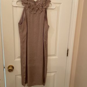 Cream colored cocktail dress with high ruffled neckline.